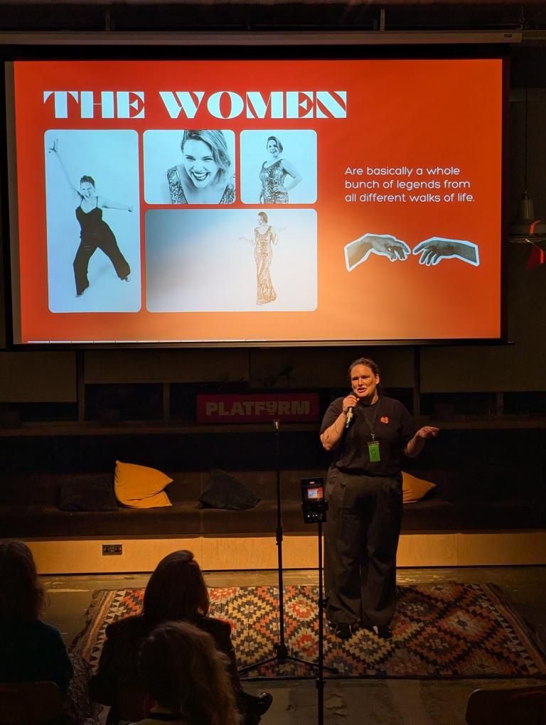 Wendy ‘wo0’ Gannon giving a talk on stage at Platform in front of a slide titled The Women